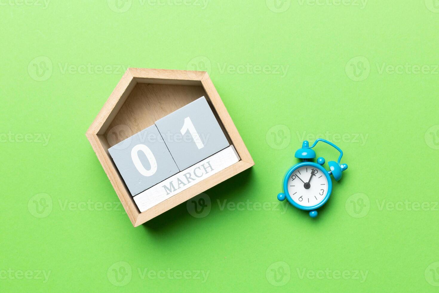 March 1st. Image of March 1 wooden block calendar on colored background. Empty space for text photo