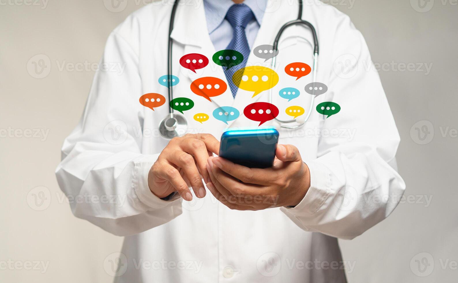 Doctor using a smartphone with colorful chat icons on application digital web and social media while standing in the hospital photo