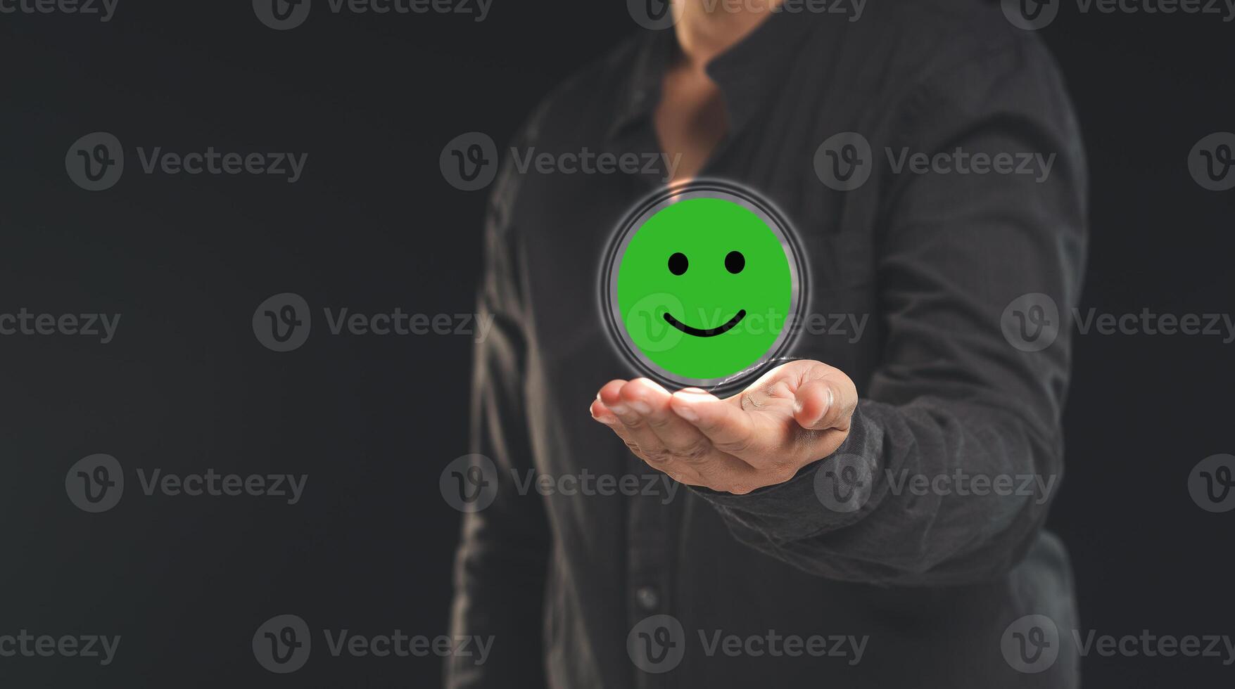Positive feedback concept. Happy mood icon in hand while standing on a black background photo