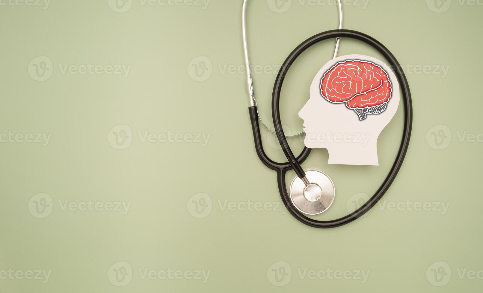 A stethoscope and a brain-shaped symbol on a green background photo