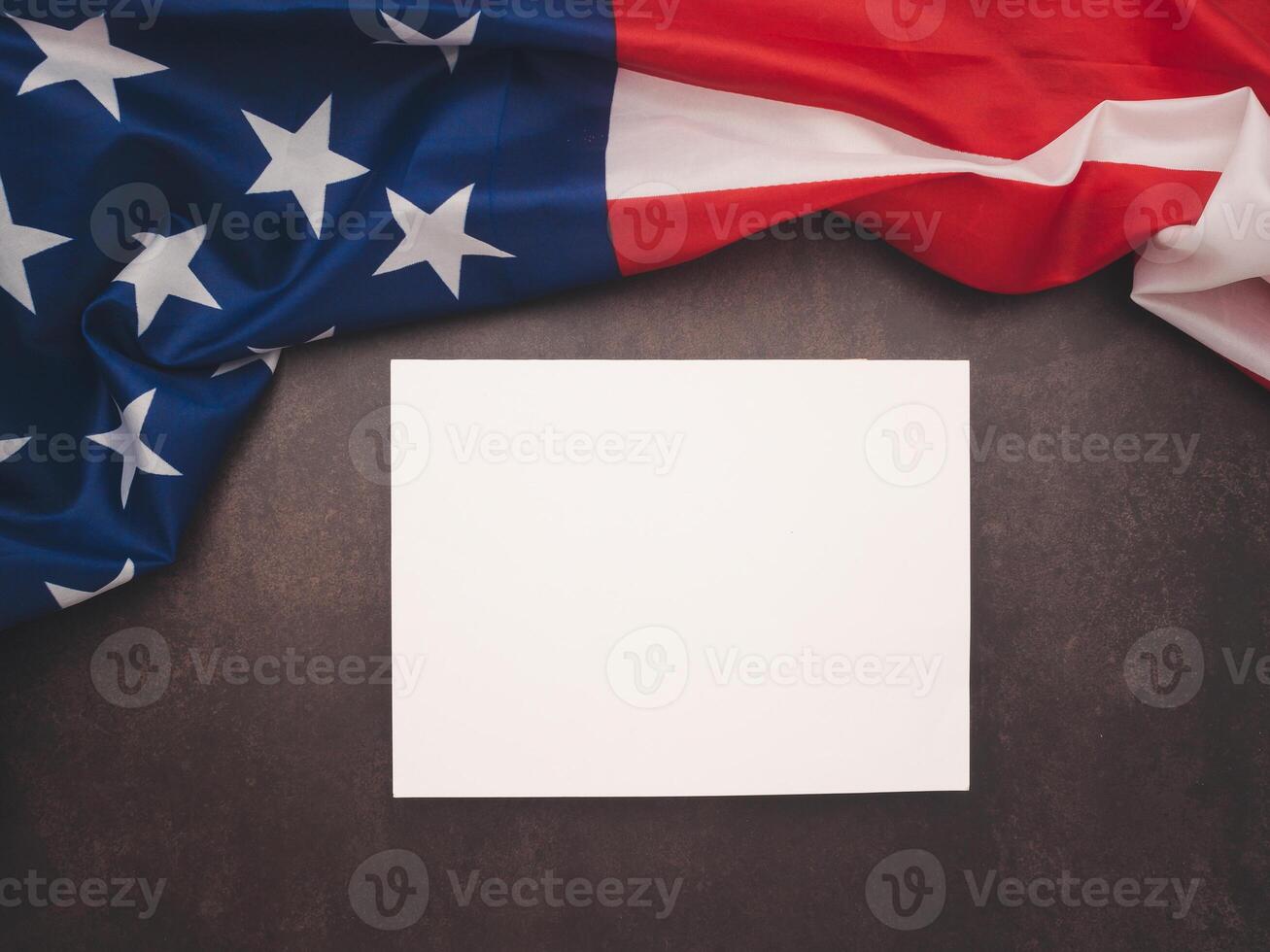 Part of the American flag and a blank white paper on a vintage background. photo