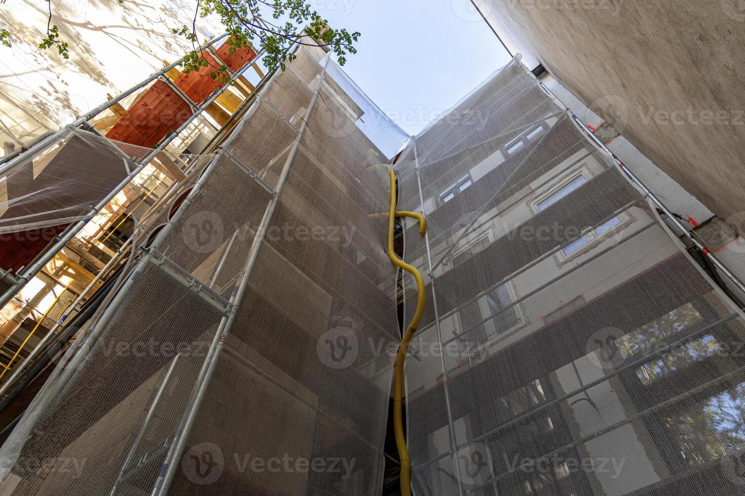Scaffolding, facade of a multi-story building, reconstruction of the facade of the house. Vienna, Austria photo