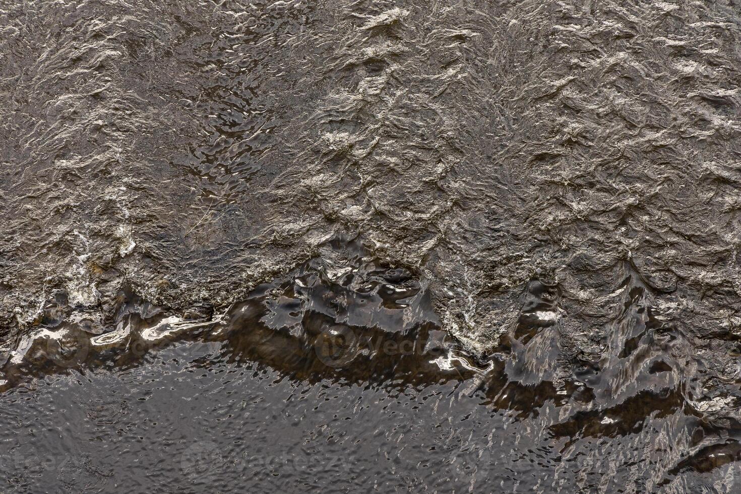 The flow of water in the Elbe River near Dresden. View from above. Water background. photo