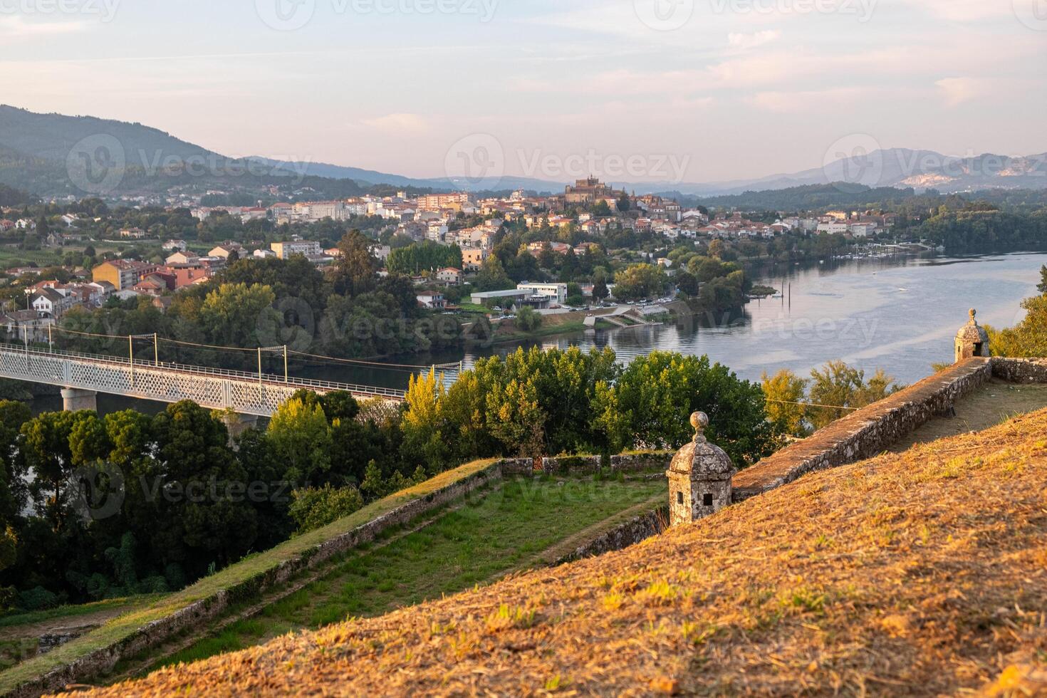 walls of the citadel of Valenca do Minho and the river Minho and galician city of Tui in the background, border between Spain and Portugal. photo