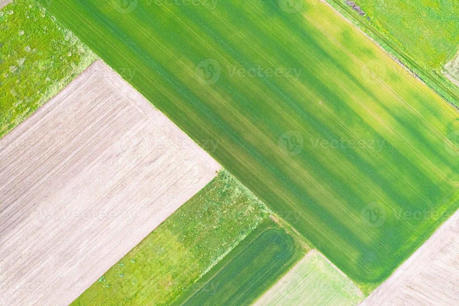 high altitude view capturing the detailed beauty of a rural farming area, aerial drone top down view photo