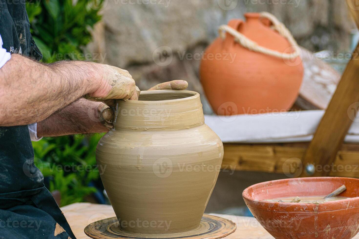 hands of a traditional potter molding a piece of clay during the celebration of a festival in Galicia, Spain. photo