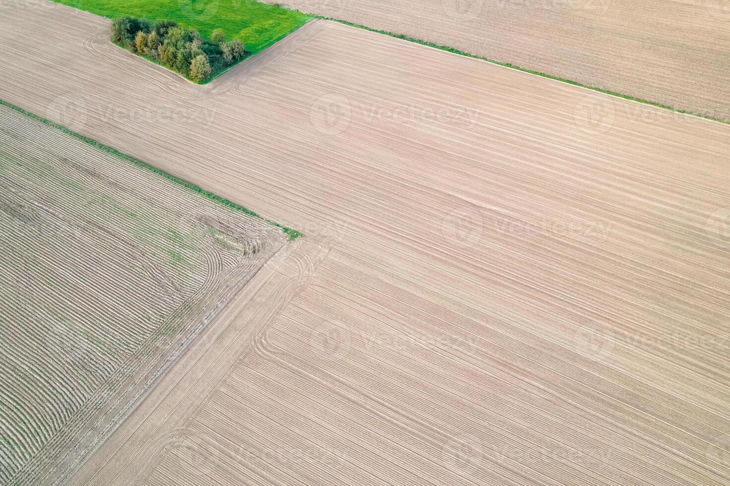drone aerial view of plowed crop fields in spring, agricultural background concept photo