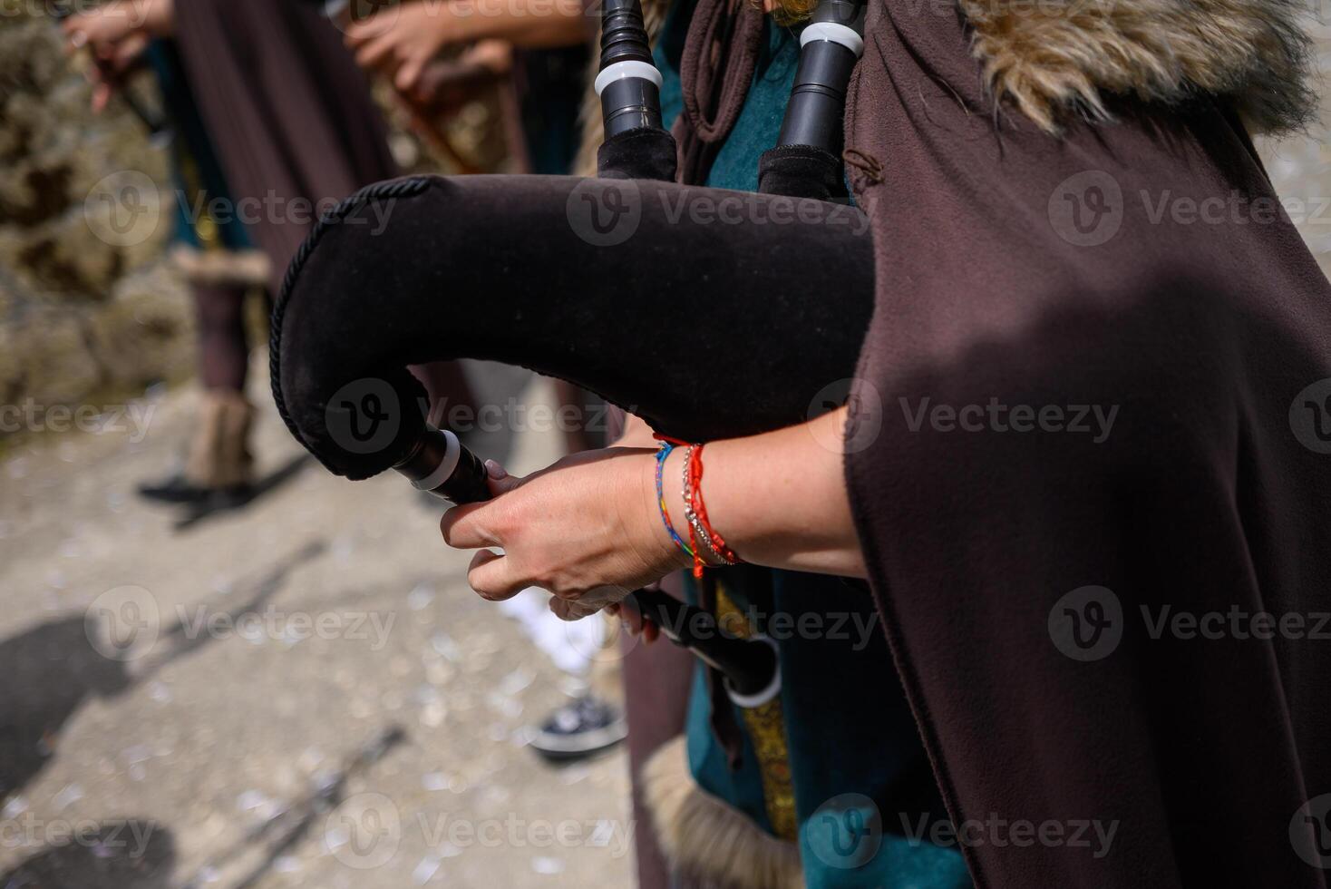 musician playing traditional bagpipes with black bag during a popular festival in Galicia photo