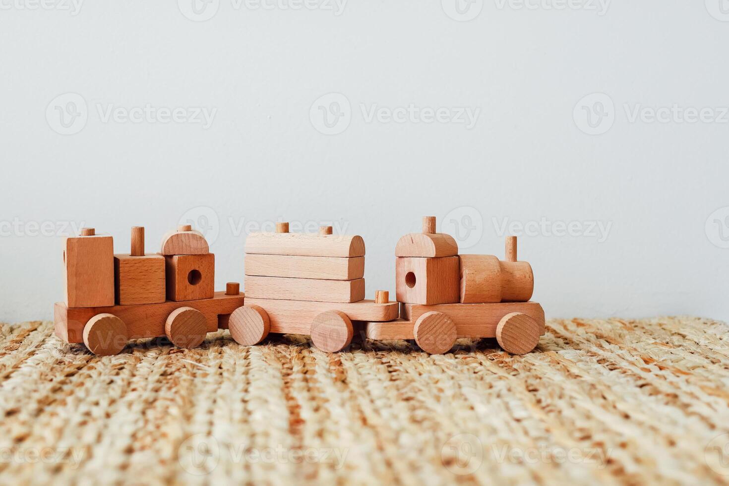 Wooden train set on natural fiber mat in a photo