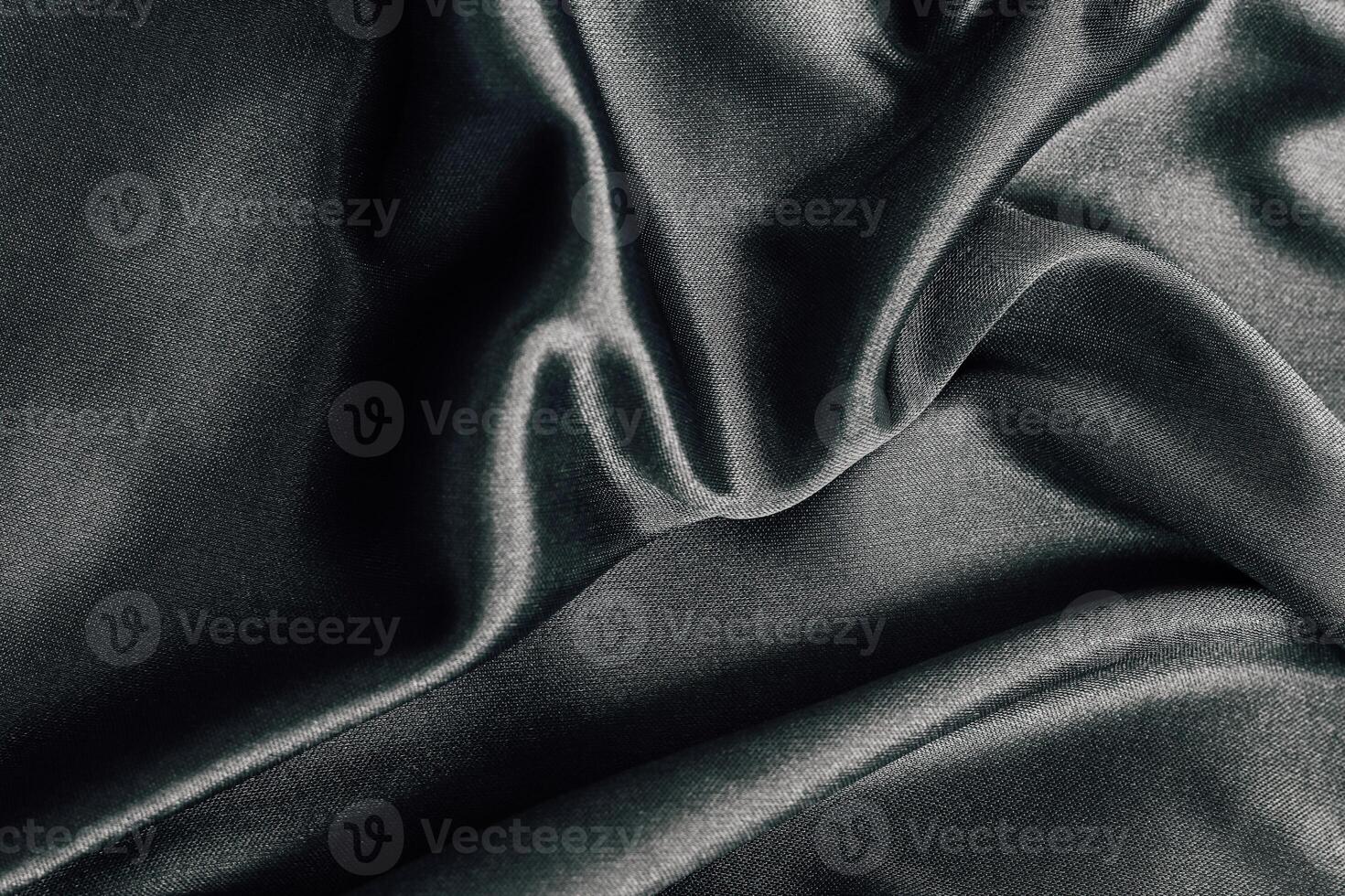 Elegant dark fabric draped softly on a smooth surface for textile design and inspiration photo