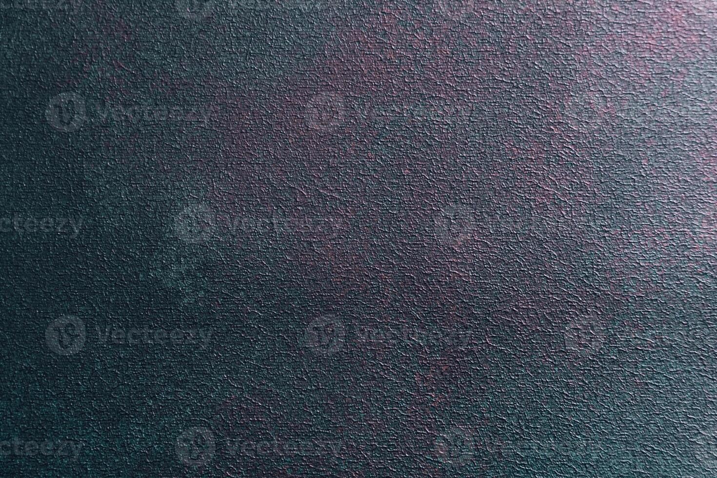 Abstract textured surface featuring dark hues and subtle lighting variations in modern design photo