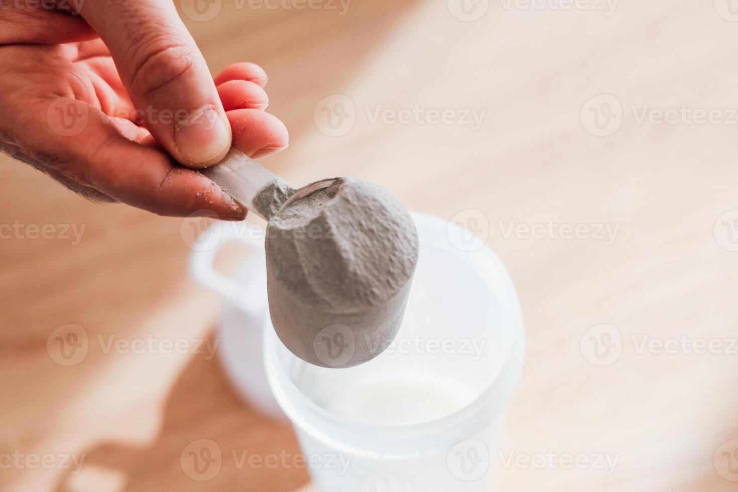 Mixing powdered sports protein for a smooth blend in a shaker photo