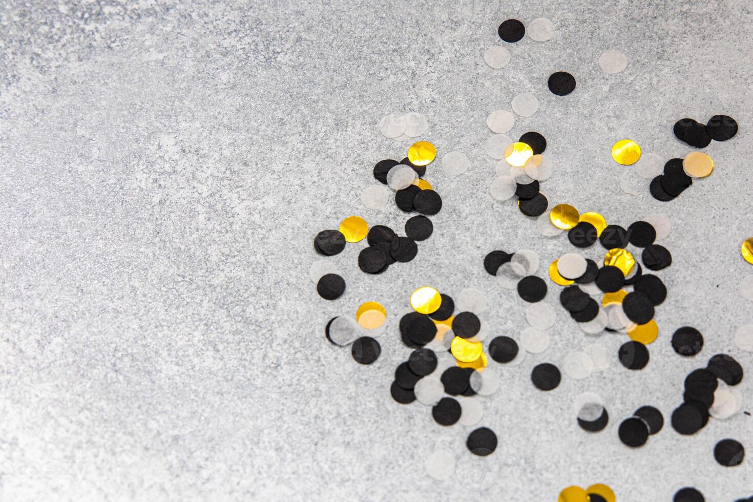 Colorful confetti scattered on a silver surface for celebration events and parties photo