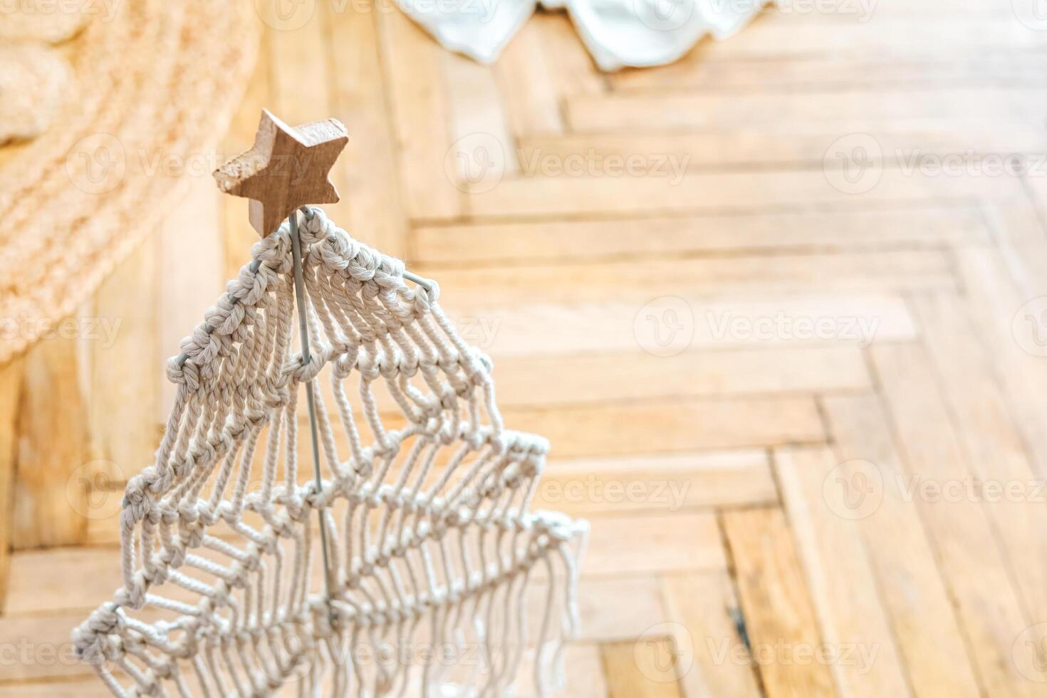 Decorative macrame Christmas tree displayed in a cozy interior setting during holiday season photo