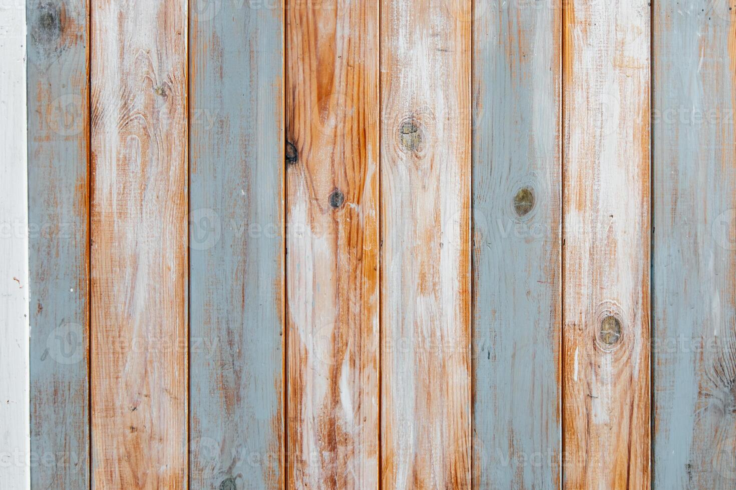 Wooden planks with varying shades of blue and orange create a rustic wall backdrop photo