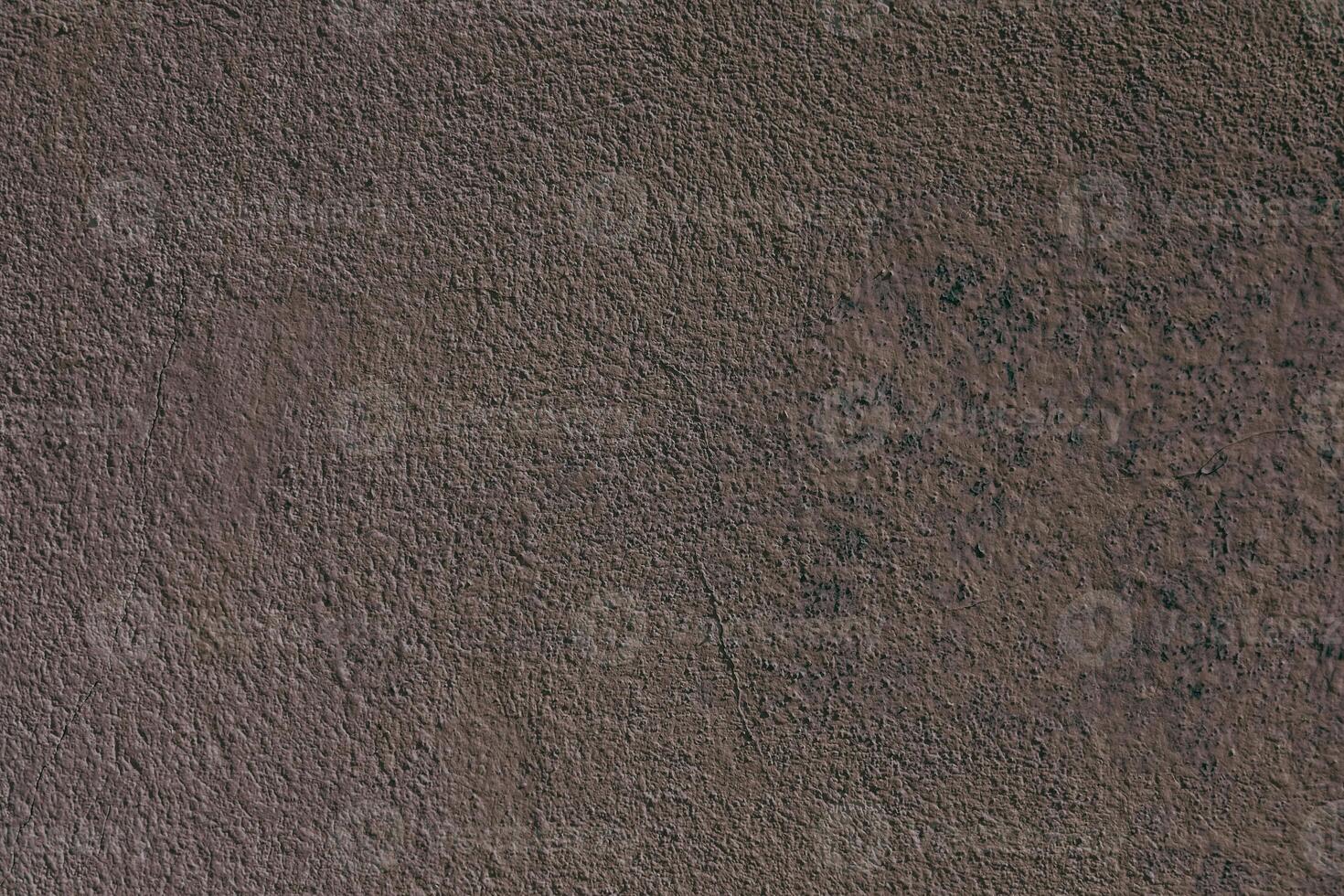 Surface texture displaying earthy tones and subtle variations in color and pattern on a wall photo