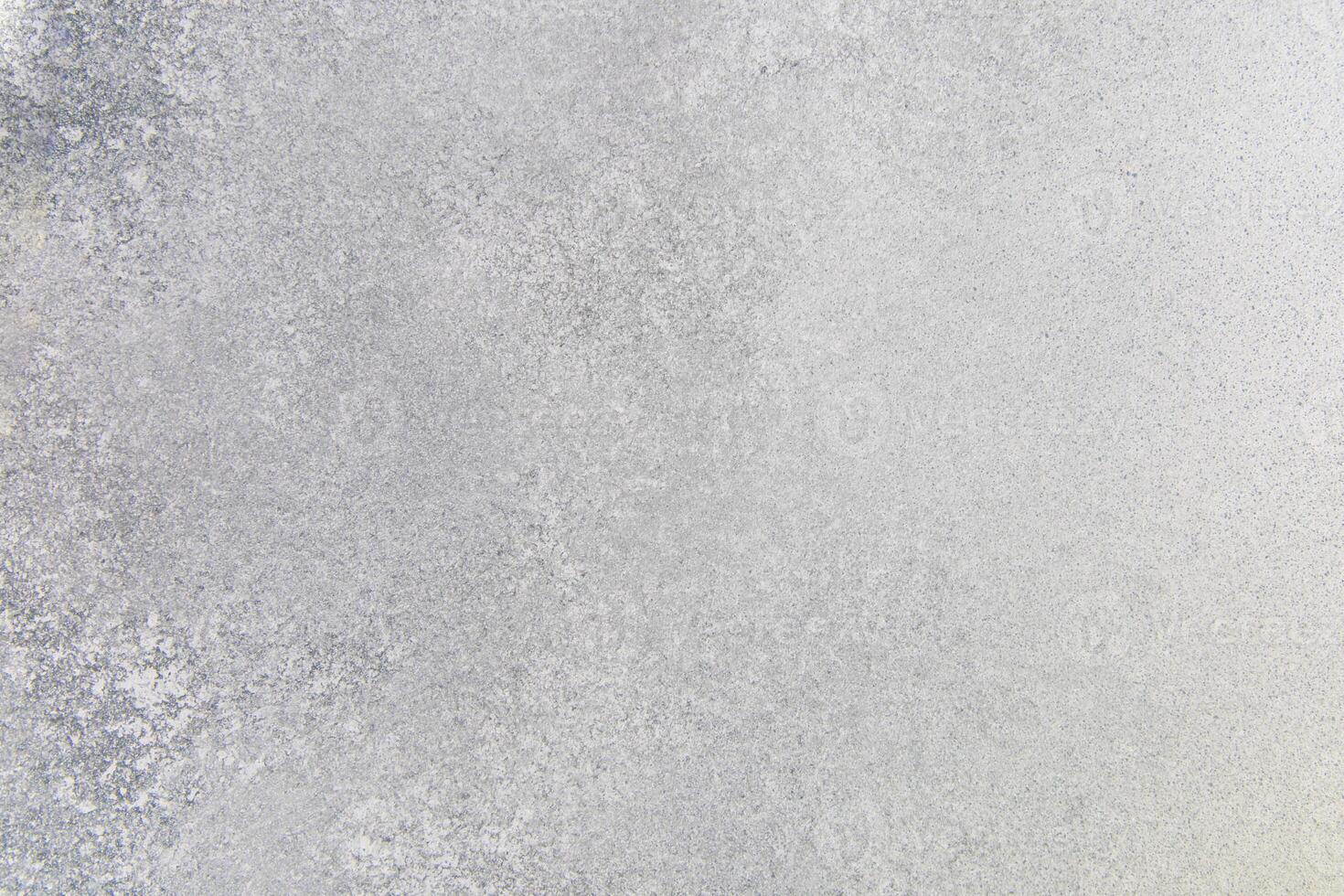 Textured surface of light gray concrete with subtle variations in tone and detail photo