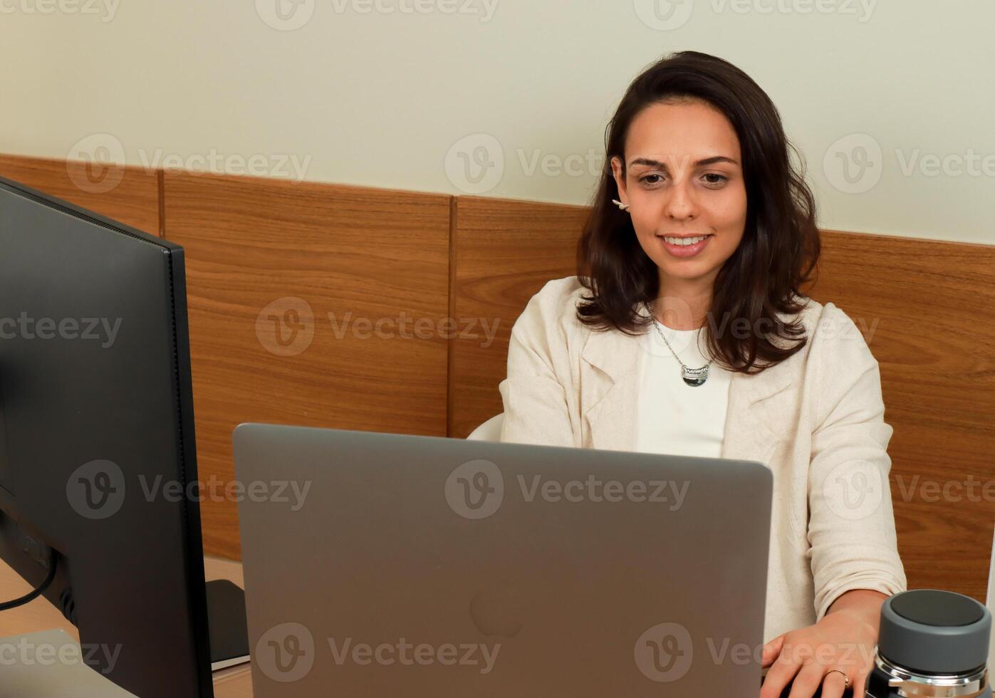 Attractive Young Professional business woman in her office working on her computer photo