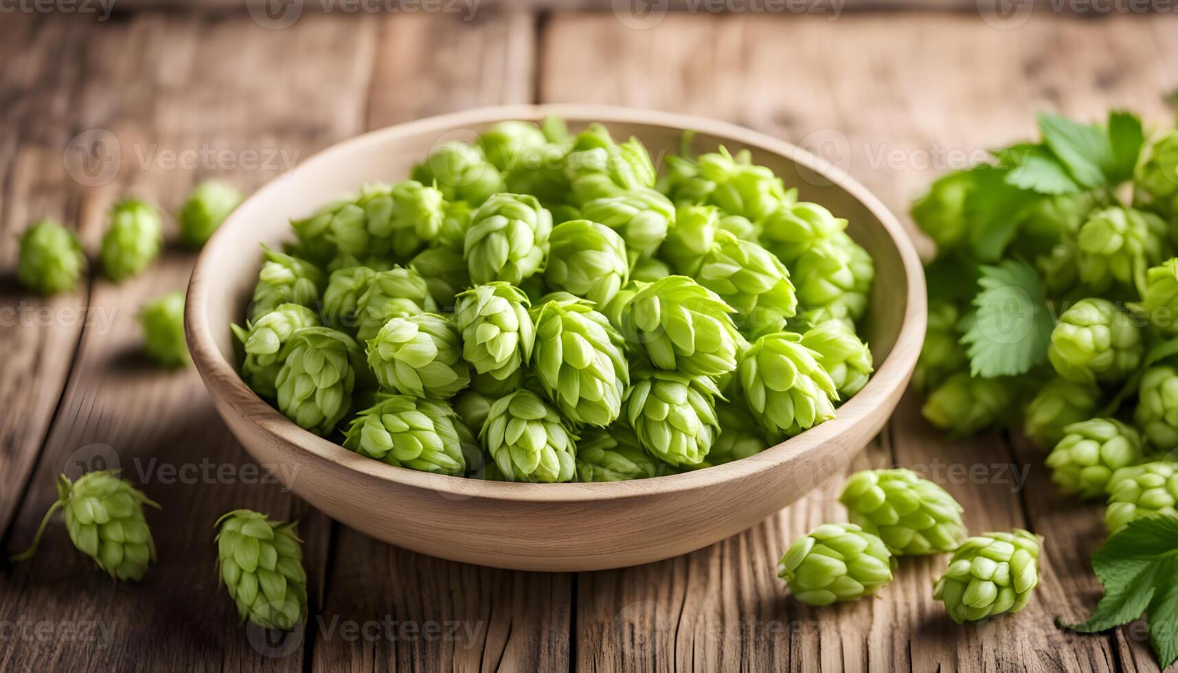Bowl with fresh green hops on wooden table, side view. photo
