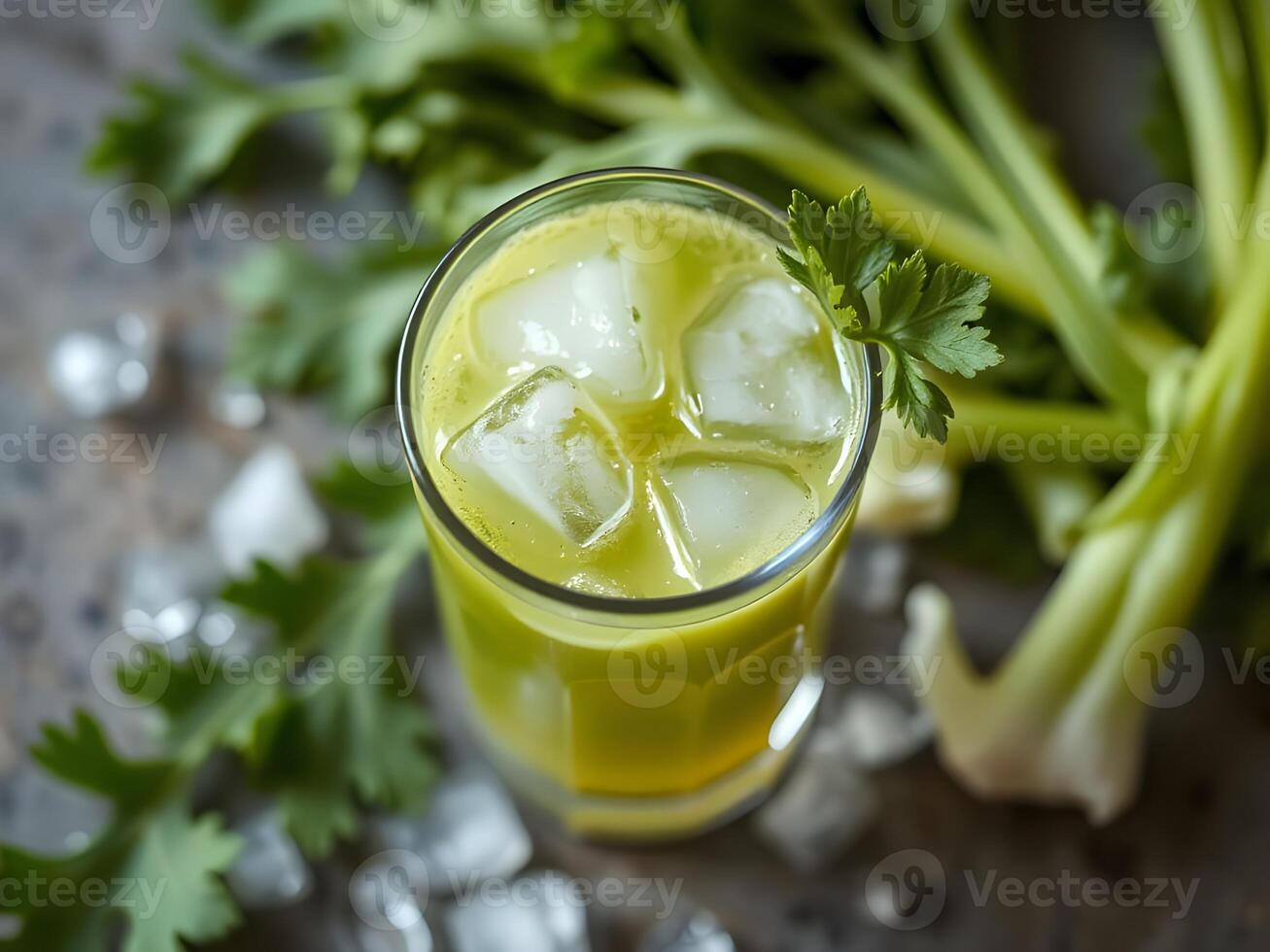 Refreshing Celery Juice with Ice Cubes and Fresh Celery photo