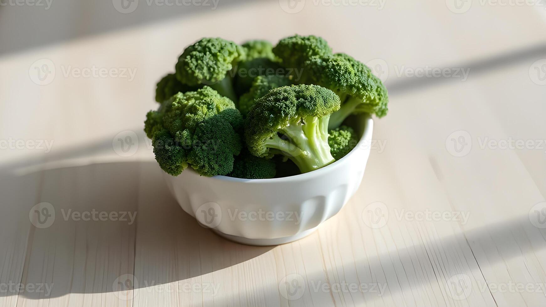 Fresh Broccoli in a White Bowl on a wooden table,side view photo
