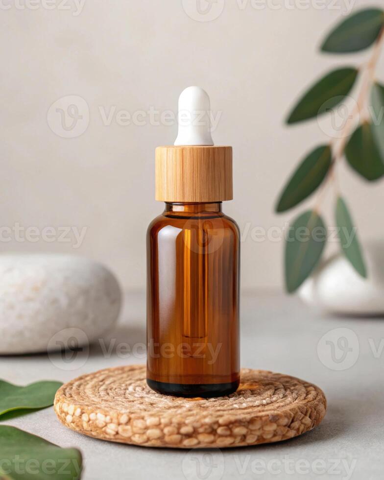 A bottle of essential oil is on a wooden plate with a green leaf and a stone photo