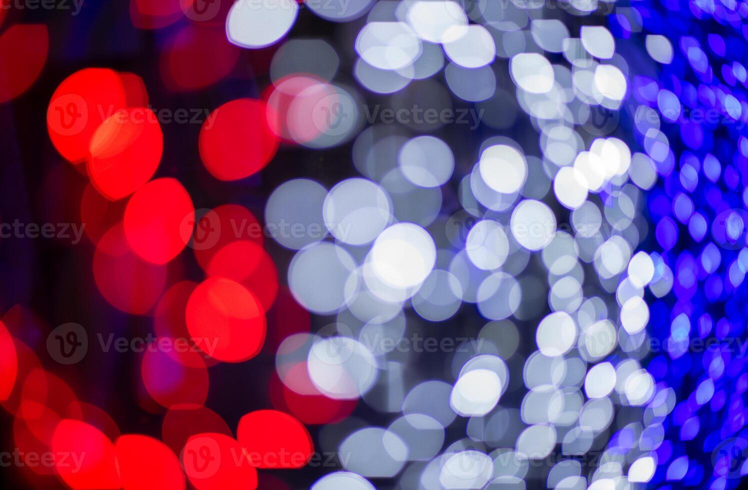 Abstract colorful bokeh red white and blue on dark background, vibrant defocused light dots pattern photo