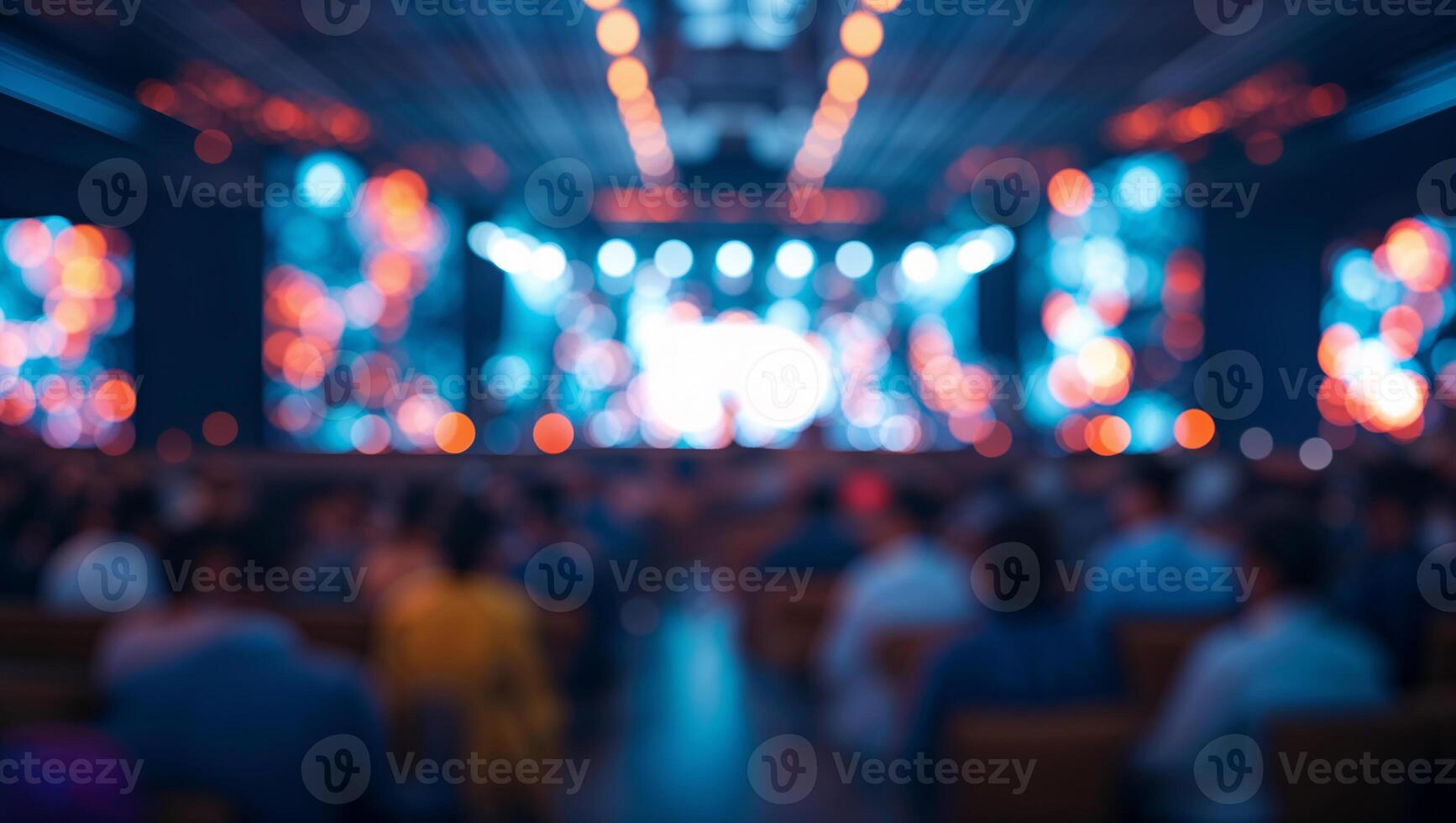 Audience watching a show with stage lights and blur effect photo