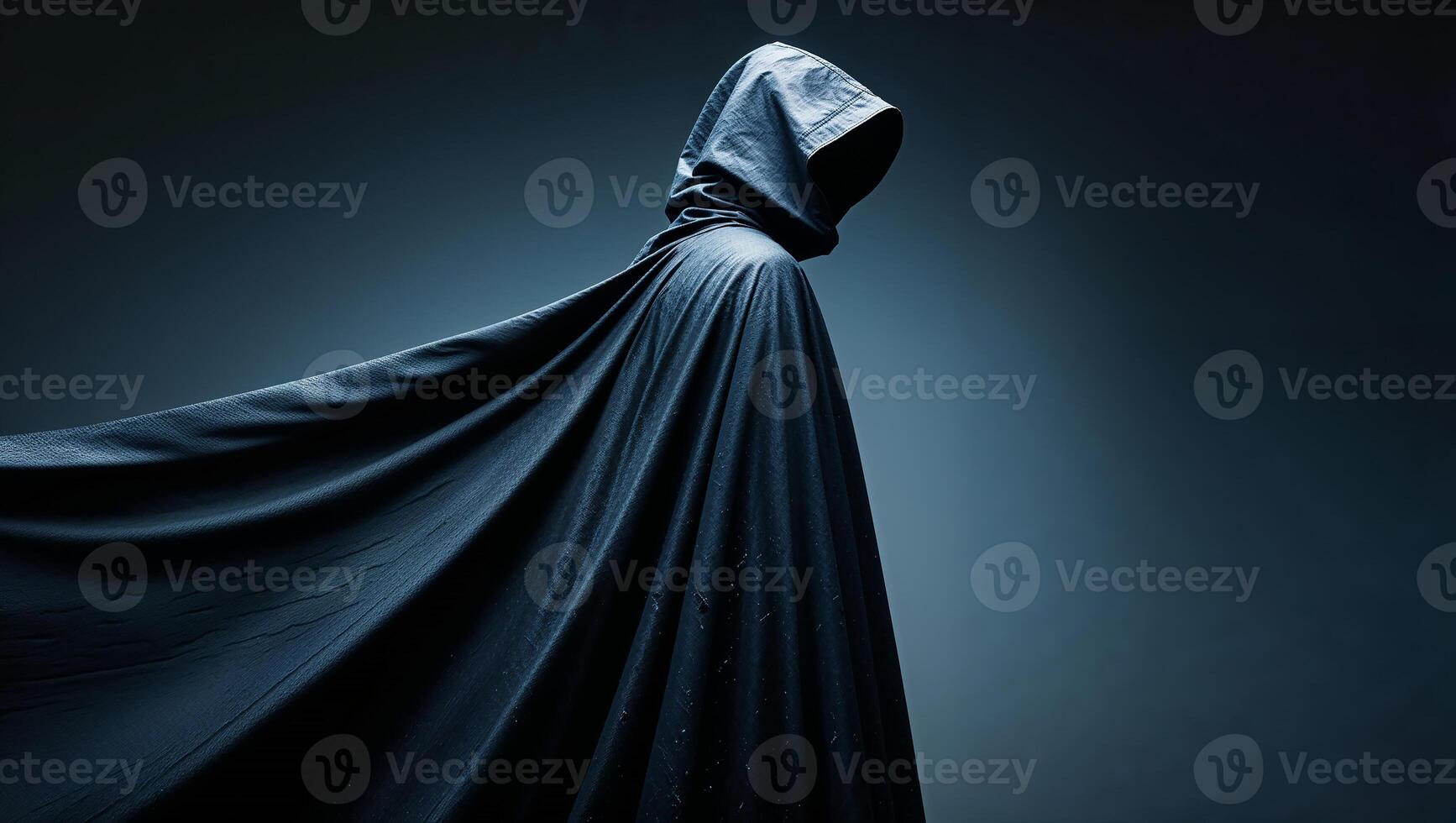 Hooded figure wearing dark cloak embraces mystery and intrigue photo
