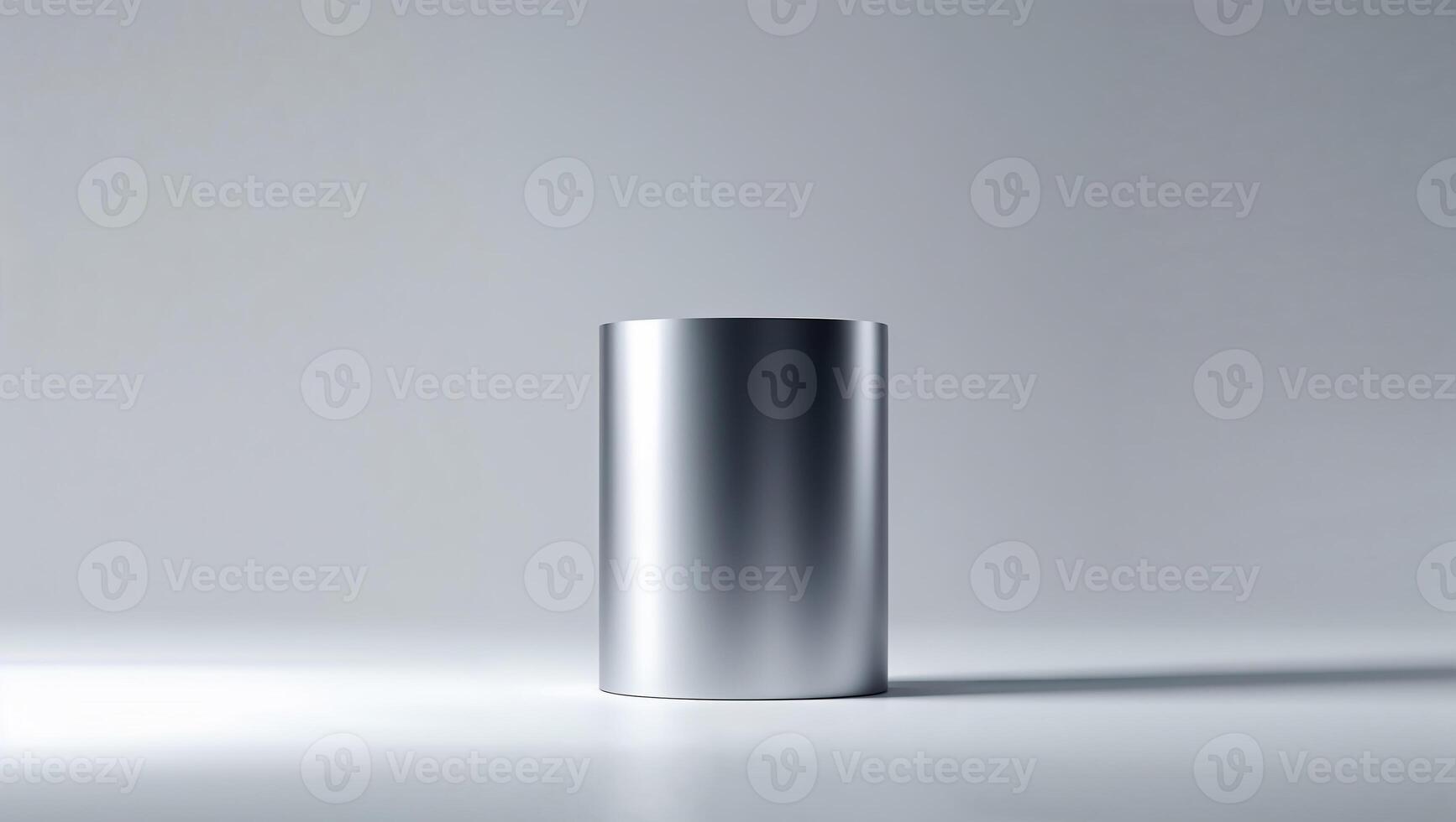 Silver metallic cylinder standing on white surface with subtle shadow photo
