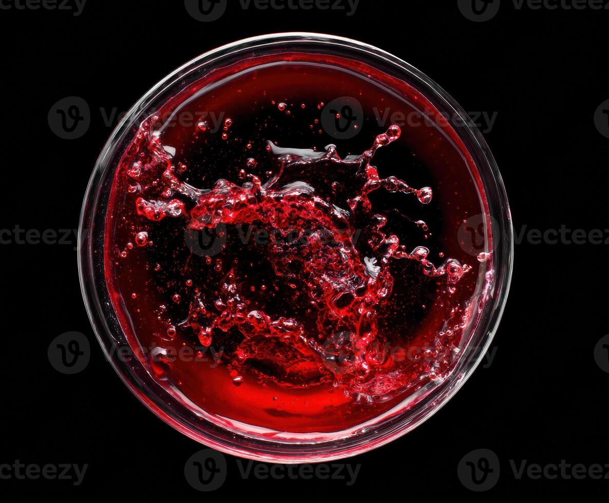 Vibrant liquid splash in a glass bowl on a dark background photo