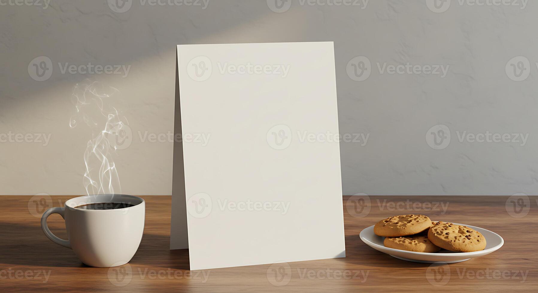 A blank white card on a table next to a cup of coffee and cookies photo