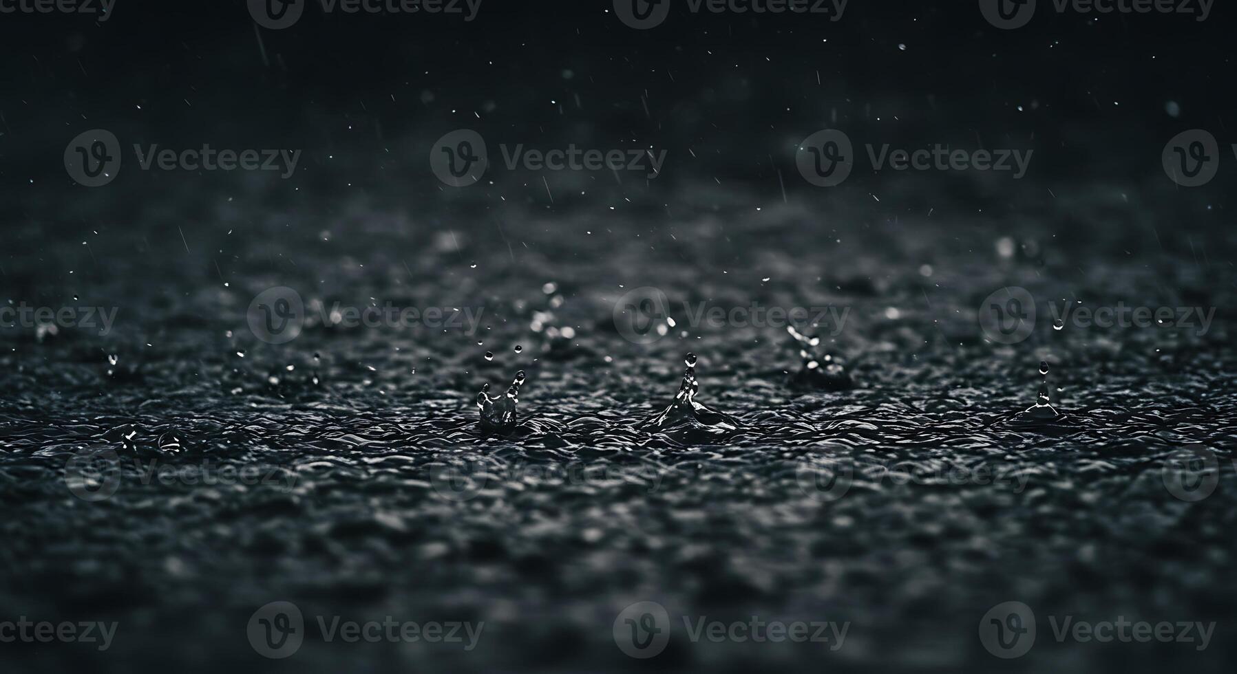 Raindrops on black asphalt photo