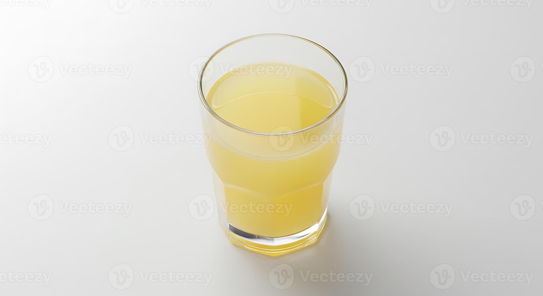 A glass of orange juice on a white surface photo