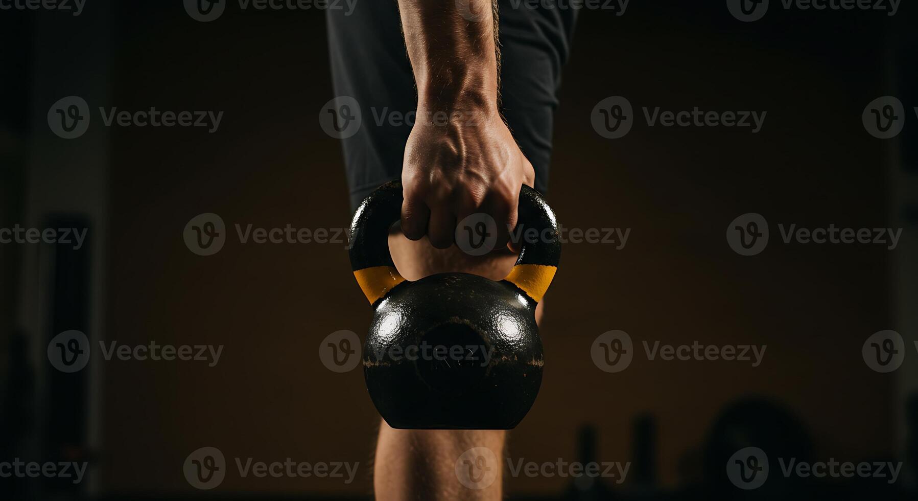 A man holding a kettlebell in his hand photo
