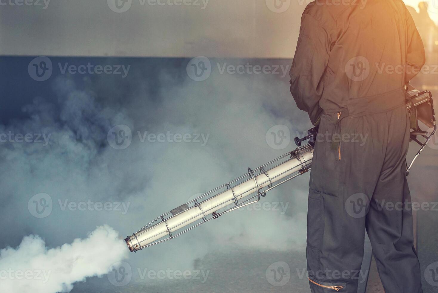 Man fogging to eliminate mosquito for prevent spread dengue fever photo