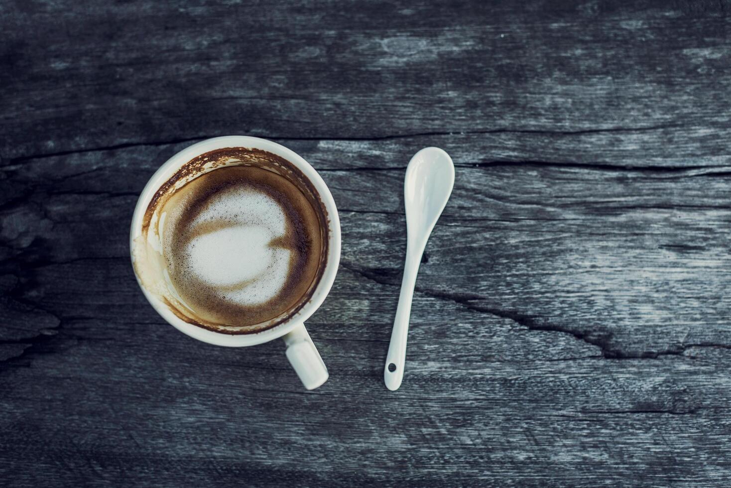 A cup of coffee in wooden background photo