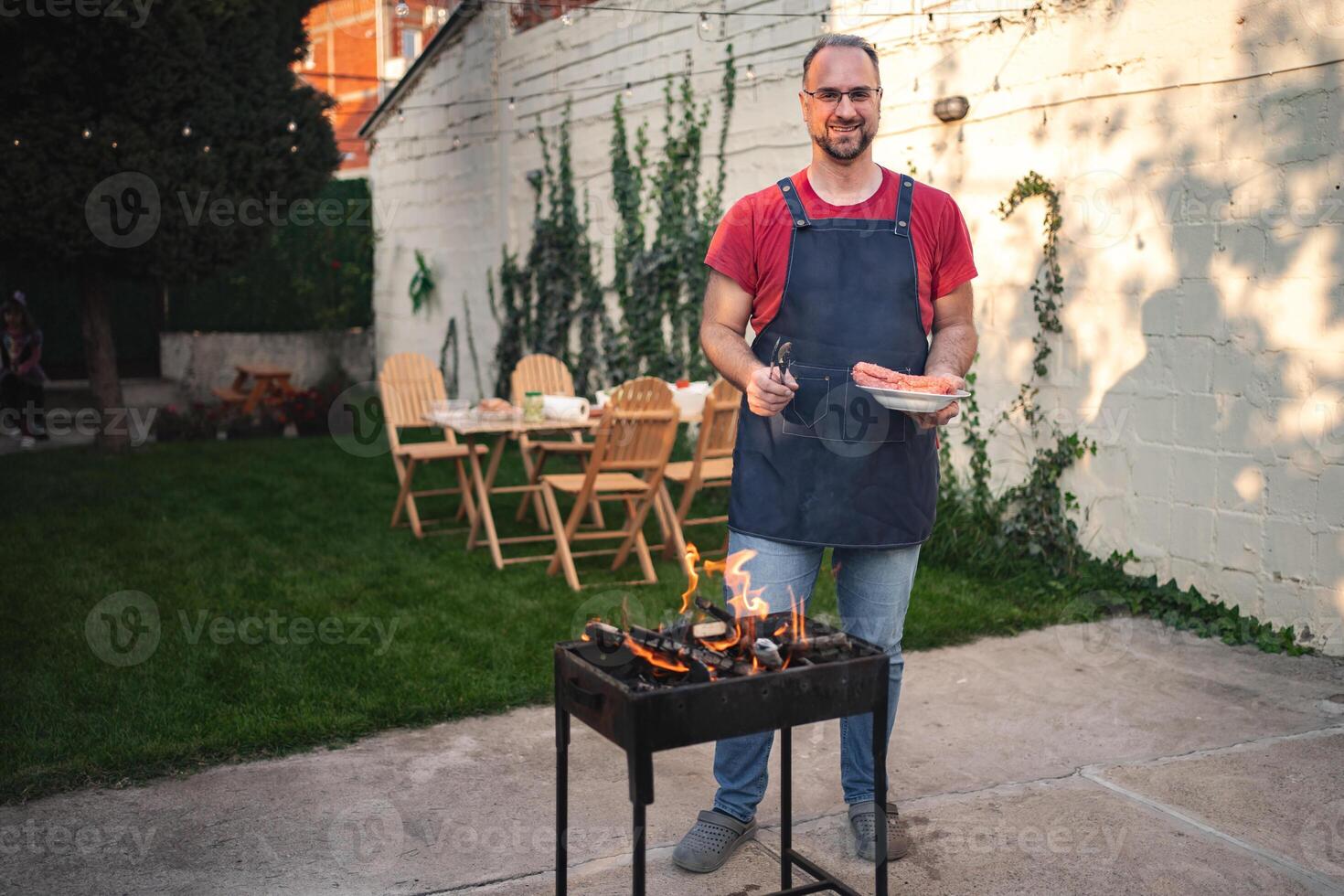 Enjoying a barbecue in a cozy backyard gathering during summer twilight photo