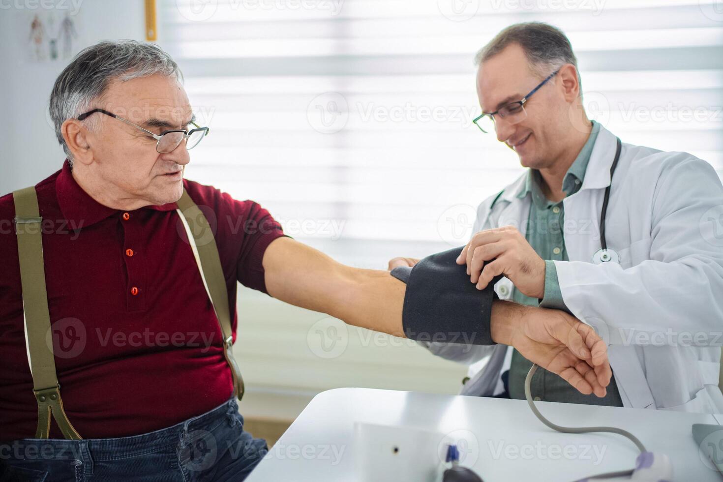 Elderly patient receives blood pressure check from attentive doctor photo