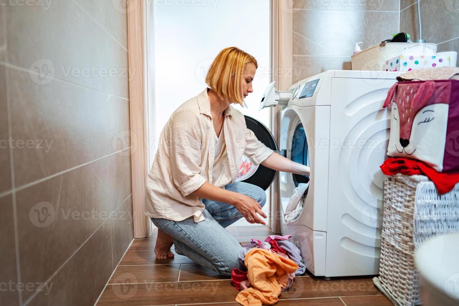 Sorting laundry in a bright and tidy laundry room photo