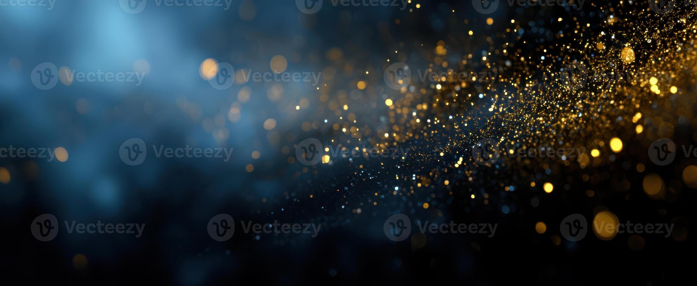 The mesmerizing golden particles shimmering against a deep blue background. photo