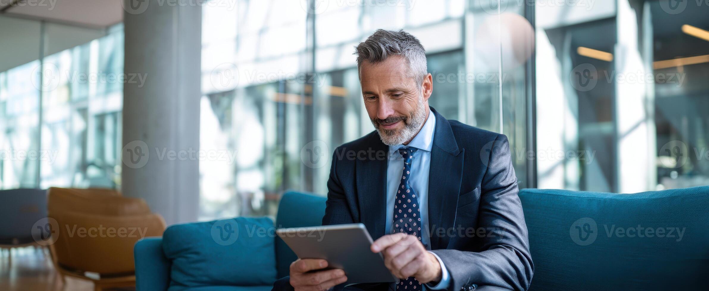 The businessman using a tablet in a modern office environment. photo