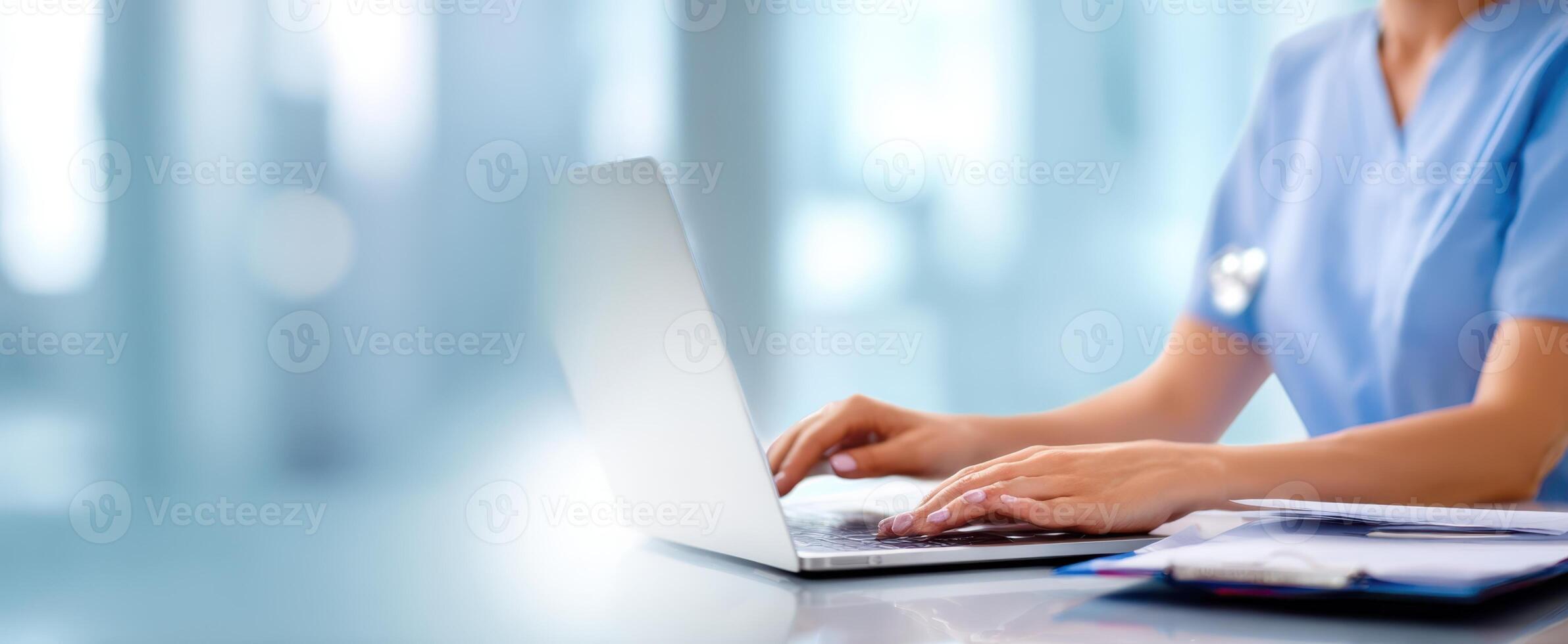 The healthcare professional using a laptop for efficient patient management. photo