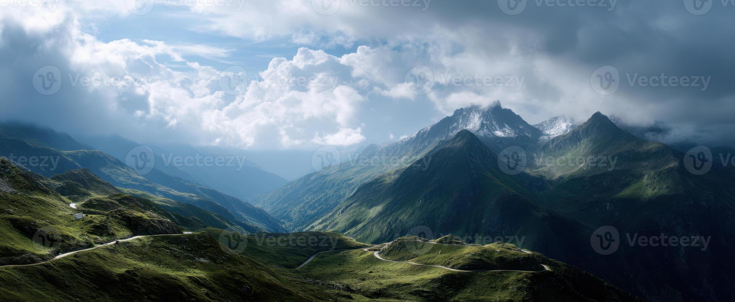 The majestic mountain landscape under dramatic clouds and vibrant skies. photo
