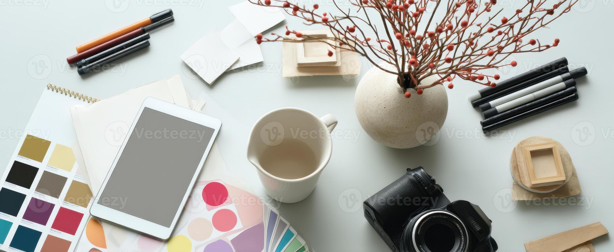 The workspace creatively arranged with artistic tools and a camera for inspiration. photo