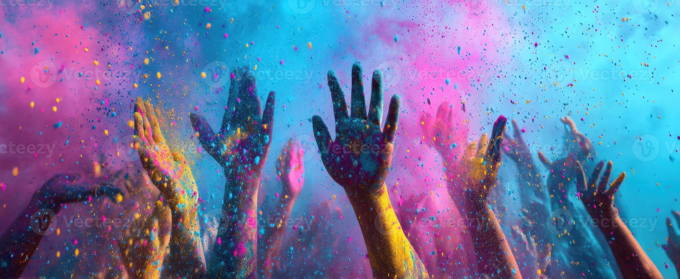 The vibrant celebration of colors with raised hands at a joyful festival. photo