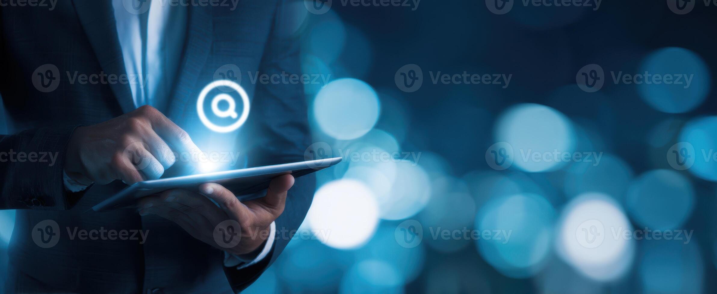 The businessman using a tablet to search in a digital environment with bokeh. photo