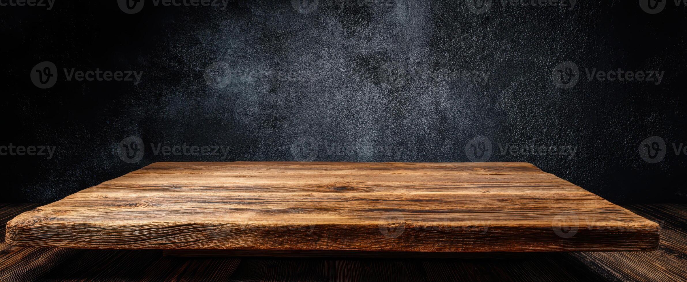 The rustic wooden table against a dark textured background for creative presentations. photo