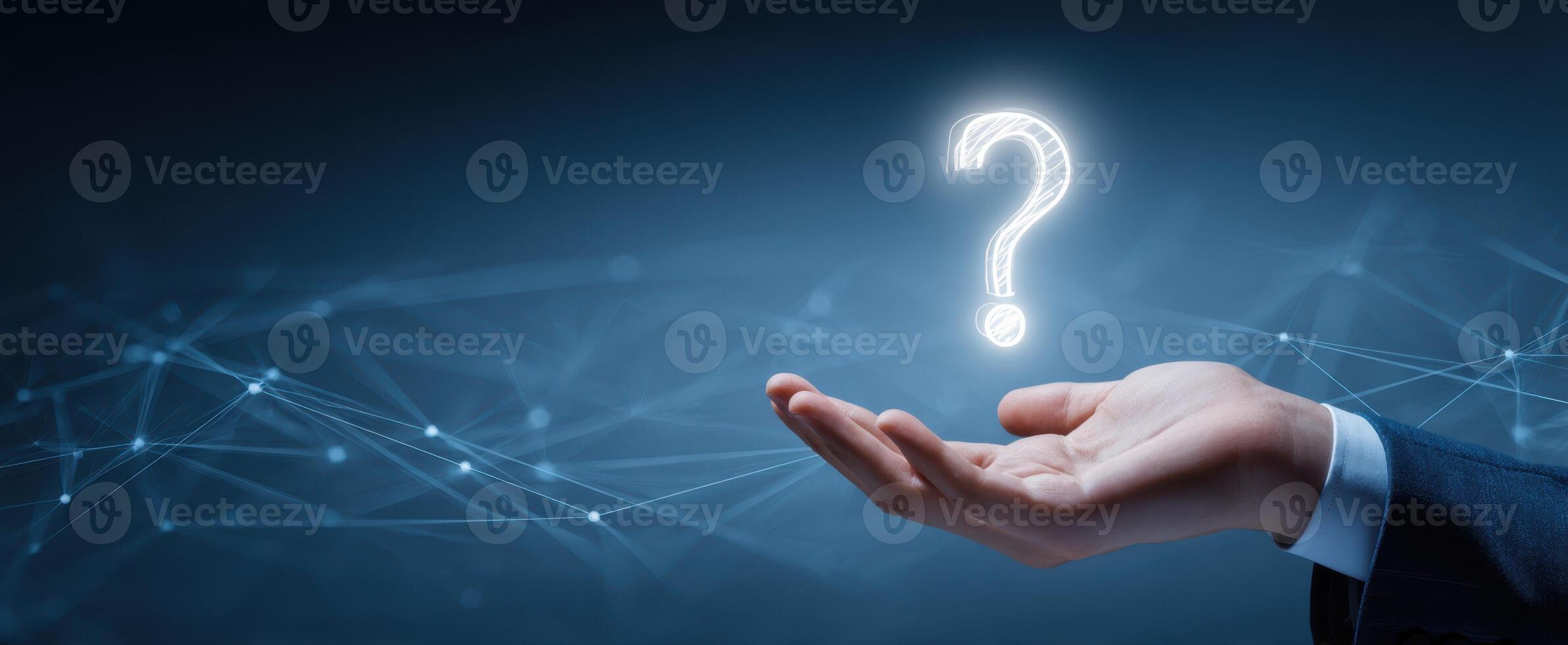 The Hand Holding a Glowing Question Mark Symbolizing Inquiry and Exploration photo