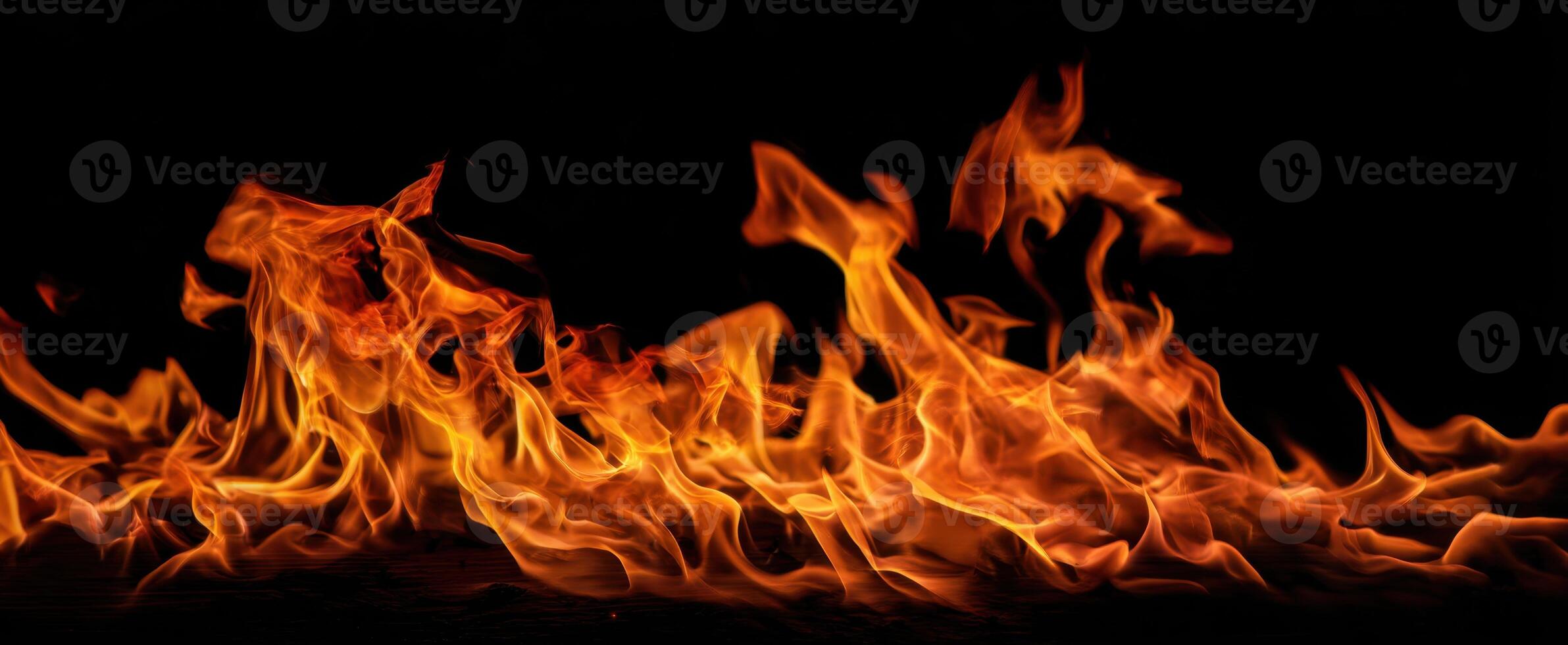 The mesmerizing flames dancing against a black backdrop in vibrant hues. photo